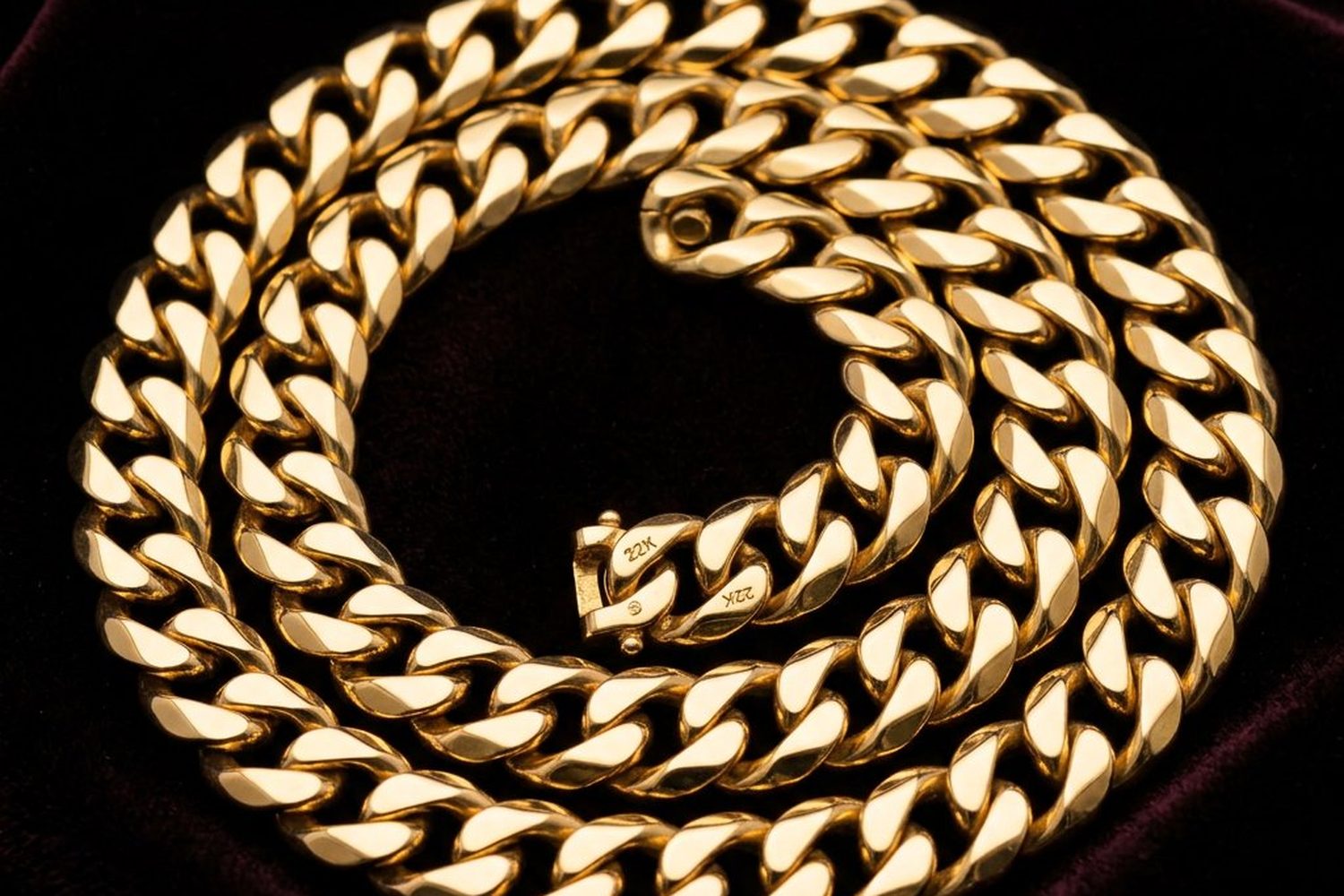 Heavy 22K gold men's curb chain photographed on black velvet